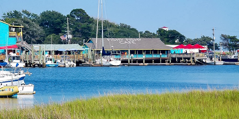 Waterfront view of restaurants and marina in Southport, NC